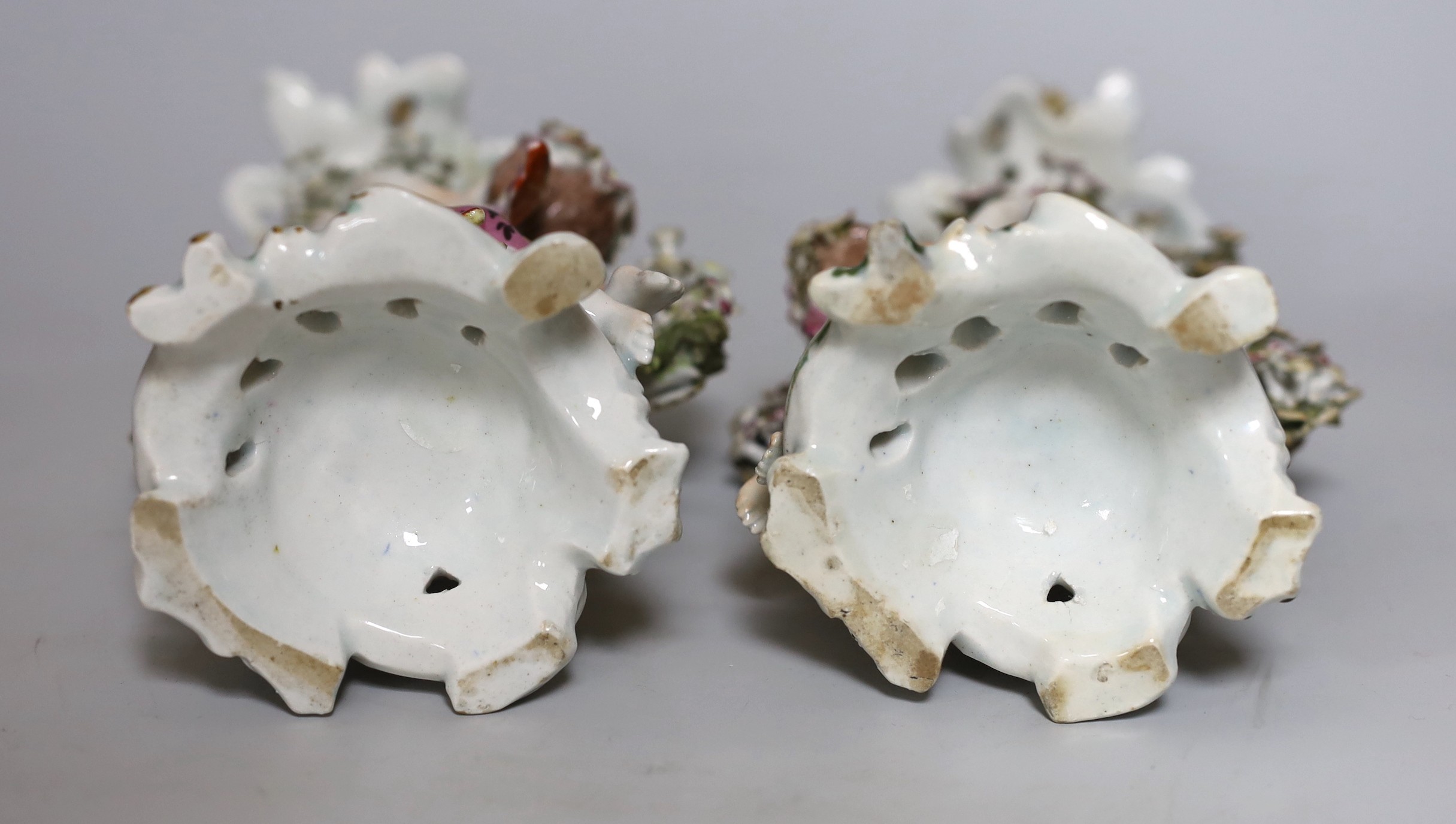 A pair of 18th century Bow putti figural candlesticks, 24cm